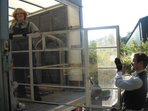 David and Daryl from the collections team help to unload the metal frame windows.